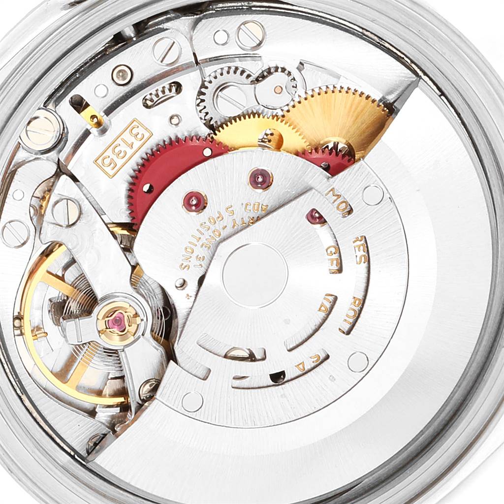 This close-up photo highlights the intricate inner mechanism of a Rolex Datejust 16220 Men's Stainless Steel Blue Dial 16220 Men's Stainless Steel Blue Dial watch, showcasing gears and components.