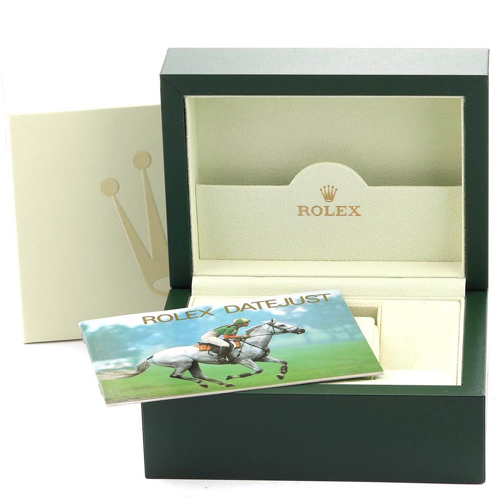 This image shows an open Rolex Datejust 16220 Men's Stainless Steel White Dial 16220 Men's Stainless Steel White Dial watch box with an instruction manual placed inside.