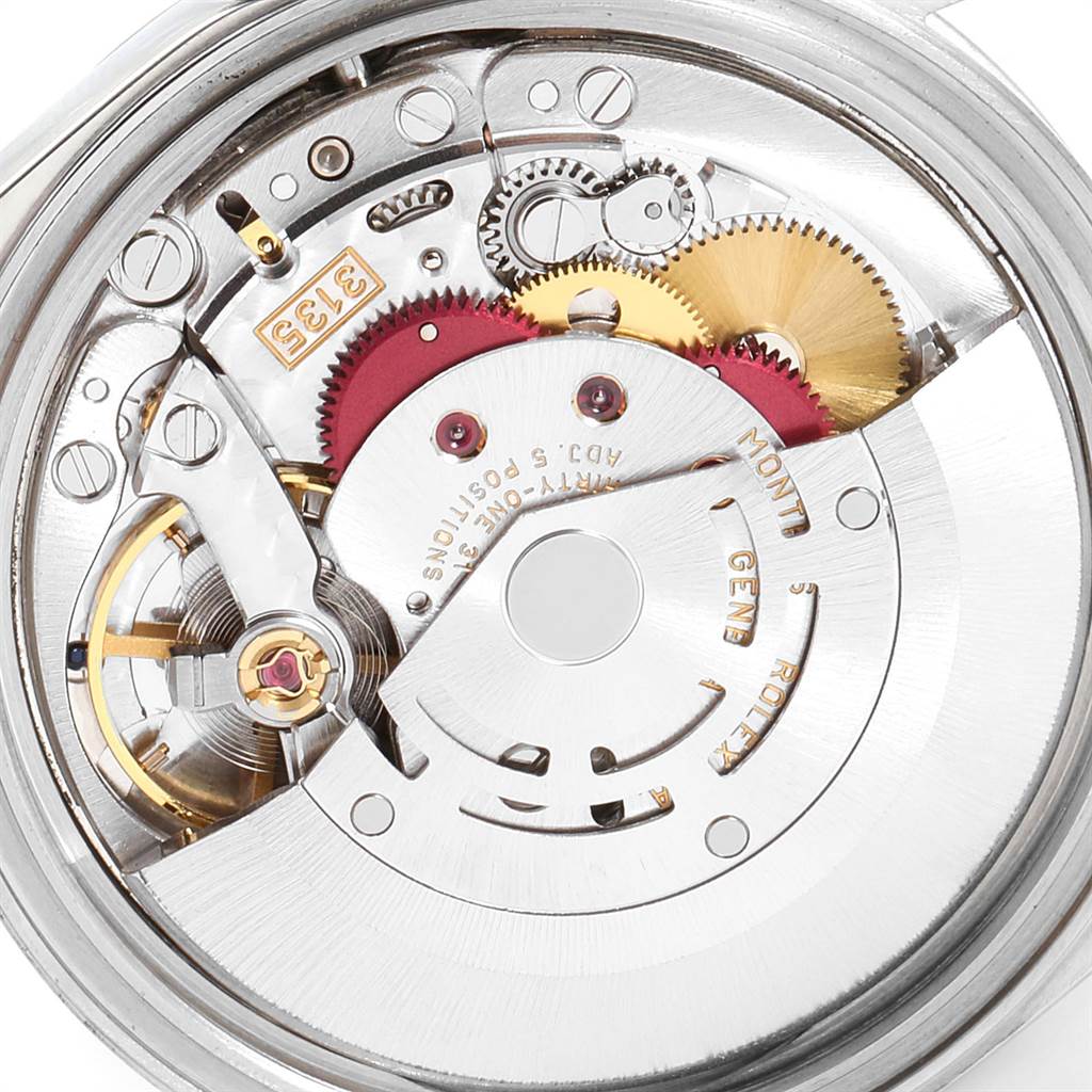 The image shows a close-up view of the movement inside a Rolex Datejust 16234 Men
s Stainless Steel Pink Dial 16234 Men
s Stainless Steel Pink Dial watch, highlighting the intricate gears and mechanisms.