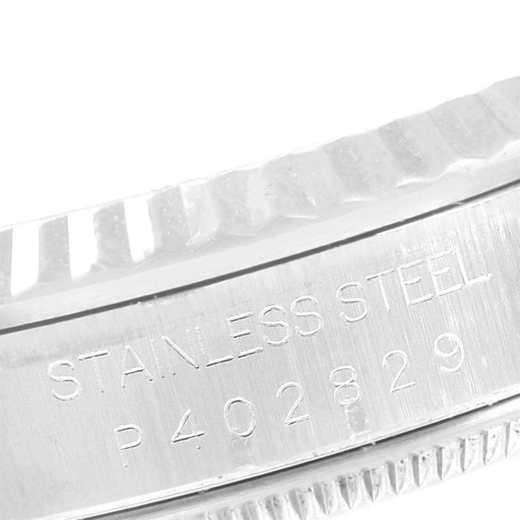 The image shows a close-up angled view of the stainless steel case back and fluted bezel of the Rolex Datejust 16234 Men
s Stainless Steel Pink Dial 16234 Men
s Stainless Steel Pink Dial watch.