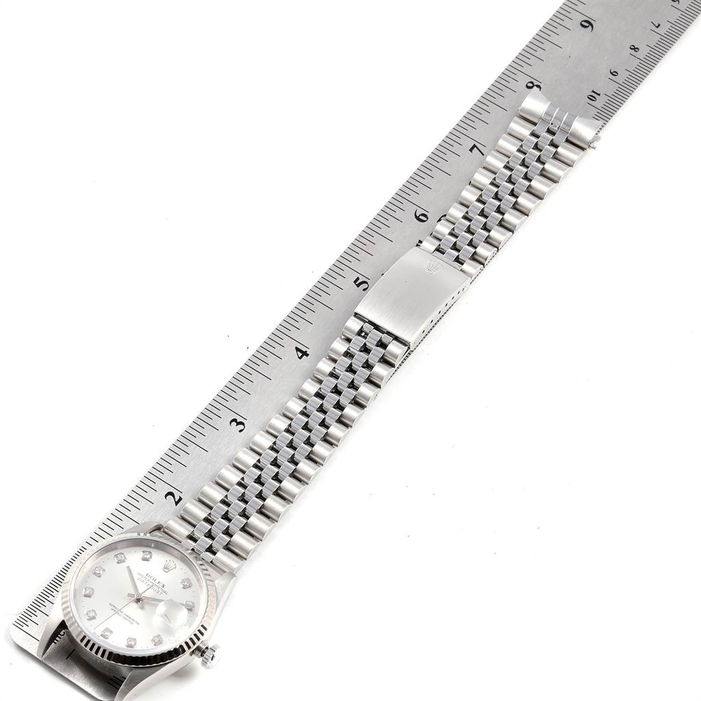 The image shows a Rolex Datejust 16234 Men's Stainless Steel Silver Dial 16234 Men's Stainless Steel Silver Dial watch and its bracelet placed alongside a ruler for measurement.