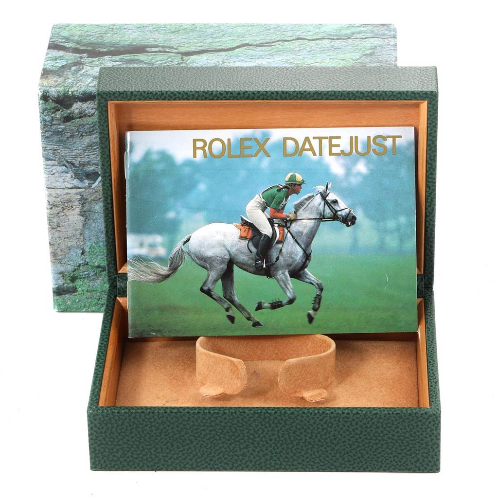 The image shows an open Rolex Datejust 16234 Men's Stainless Steel Silver Dial 16234 Men's Stainless Steel Silver Dial watch box with a booklet inside featuring a horse rider.