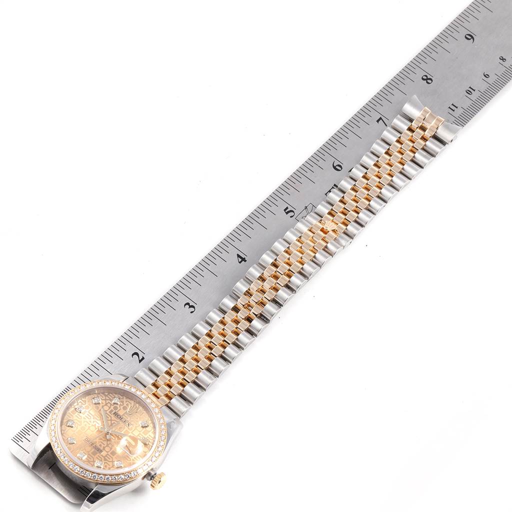 The image shows a Rolex Datejust 116243 Men
s Steel and Gold (two tone) Champagne Dial 116243 Men
s Steel and Gold (two tone) Champagne Dial watch laid flat alongside a ruler, displaying the face and the full length of the band.