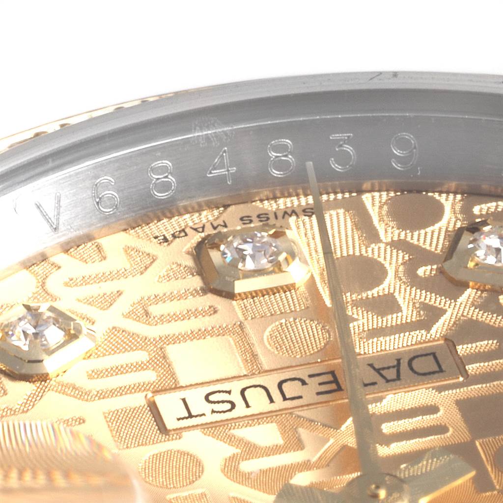 This close-up image of the Rolex Datejust 116243 Men
s Steel and Gold (two tone) Champagne Dial 116243 Men
s Steel and Gold (two tone) Champagne Dial shows part of the watch
s dial with diamond markers and partial serial number.