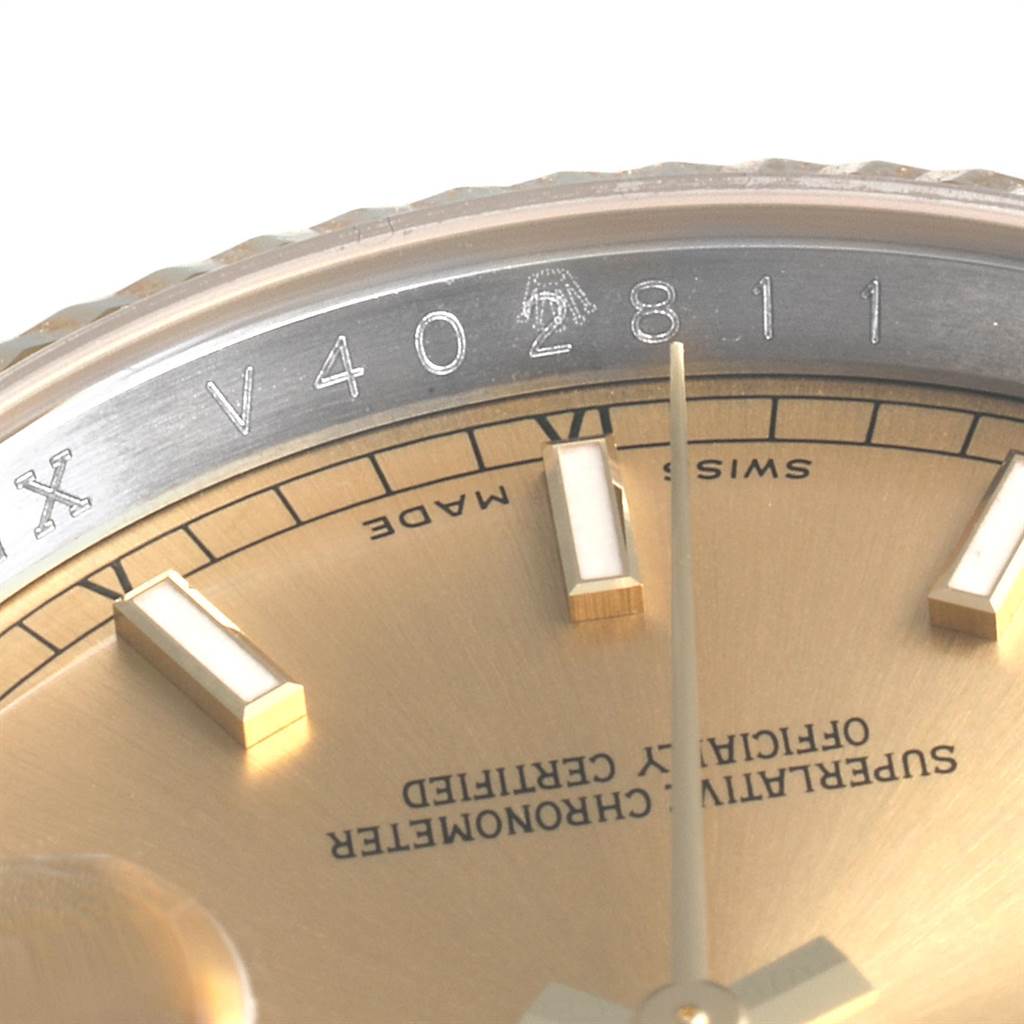 The image shows a close-up angle of the Rolex Datejust 116233 Men's Stainless Steel Champagne Dial 116233 Men's Stainless Steel Champagne Dial watch, focusing on the serial number engraving and part of the dial with hour markers.