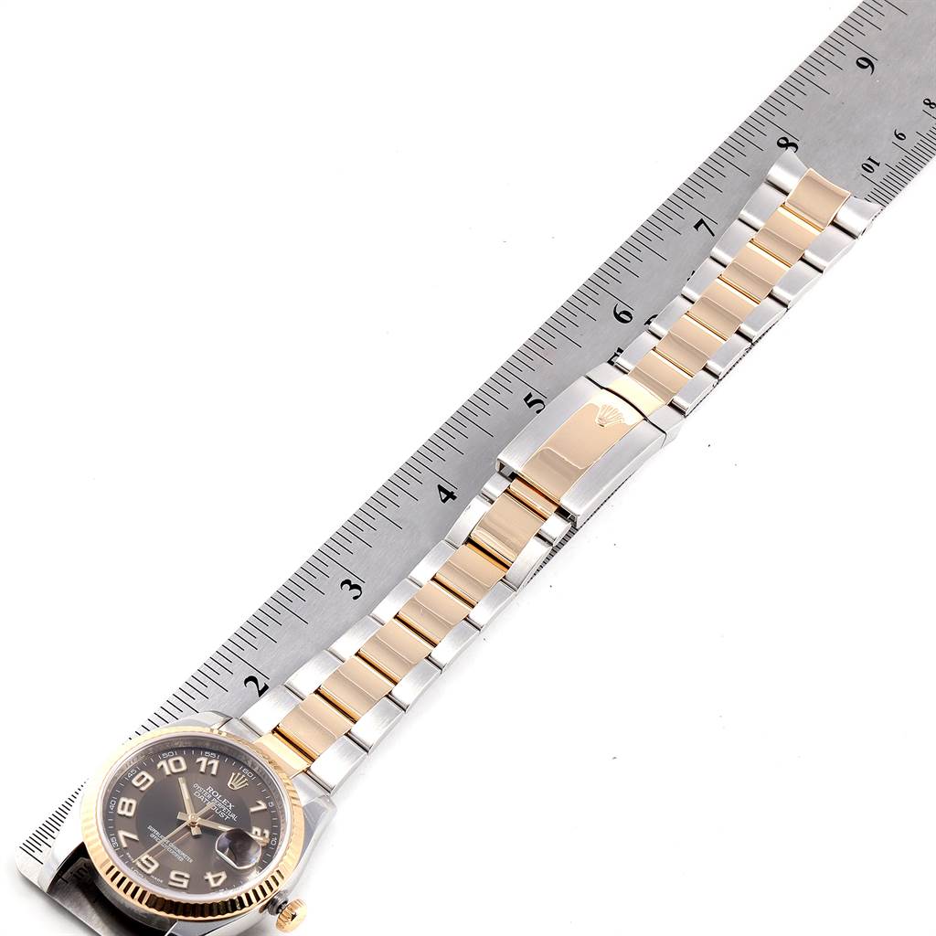 This image shows a Rolex Datejust 116233 Men's Steel and Gold (two tone) Brown Dial 116233 Men's Steel and Gold (two tone) Brown Dial watch face and bracelet, lying flat next to a ruler for scale.