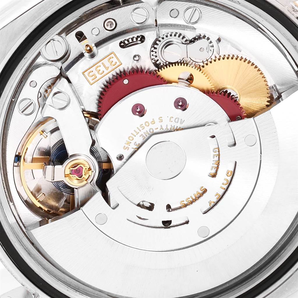 The image shows a close-up of the movement mechanism of a Rolex Datejust 116233 Men's Steel and Gold (two tone) Brown Dial 116233 Men's Steel and Gold (two tone) Brown Dial watch, highlighting gears and mechanical components.