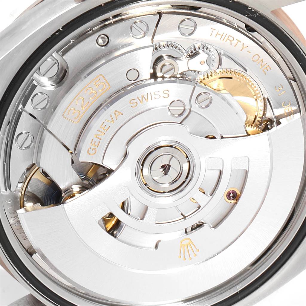 This image shows the internal mechanism of a Rolex Datejust 126231 Men
s Steel and Gold (two tone) Grey Dial 126231 Men
s Steel and Gold (two tone) Grey Dial watch, specifically the movement labeled 3235, with a clear view of gears and components.