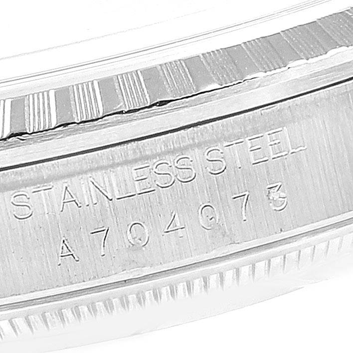 The image shows a close-up of the stainless steel bezel and case with a serial number of a Rolex Datejust 16220 Men's Stainless Steel Blue Dial 16220 Men's Stainless Steel Blue Dial watch.