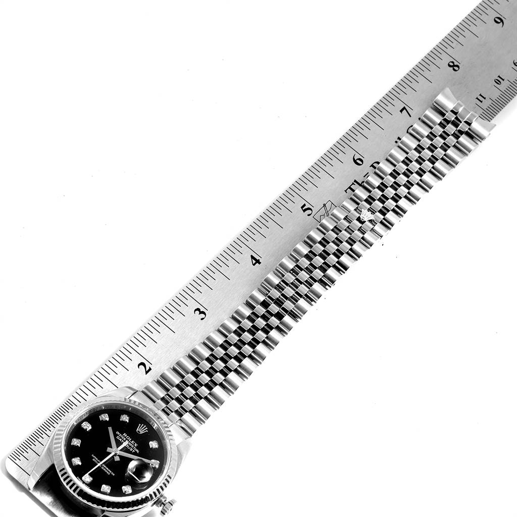 The image shows a Rolex Datejust 116234 Men's Stainless Steel Black Dial 116234 Men's Stainless Steel Black Dial watch with a black dial and diamond markers, measuring its bracelet length with a ruler.
