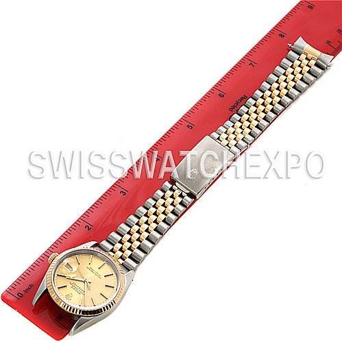 The Rolex Datejust 16233 Men's Stainless Steel White Dial 16233 Men's Stainless Steel White Dial watch is shown fully extended, laying flat next to a red ruler for scale.