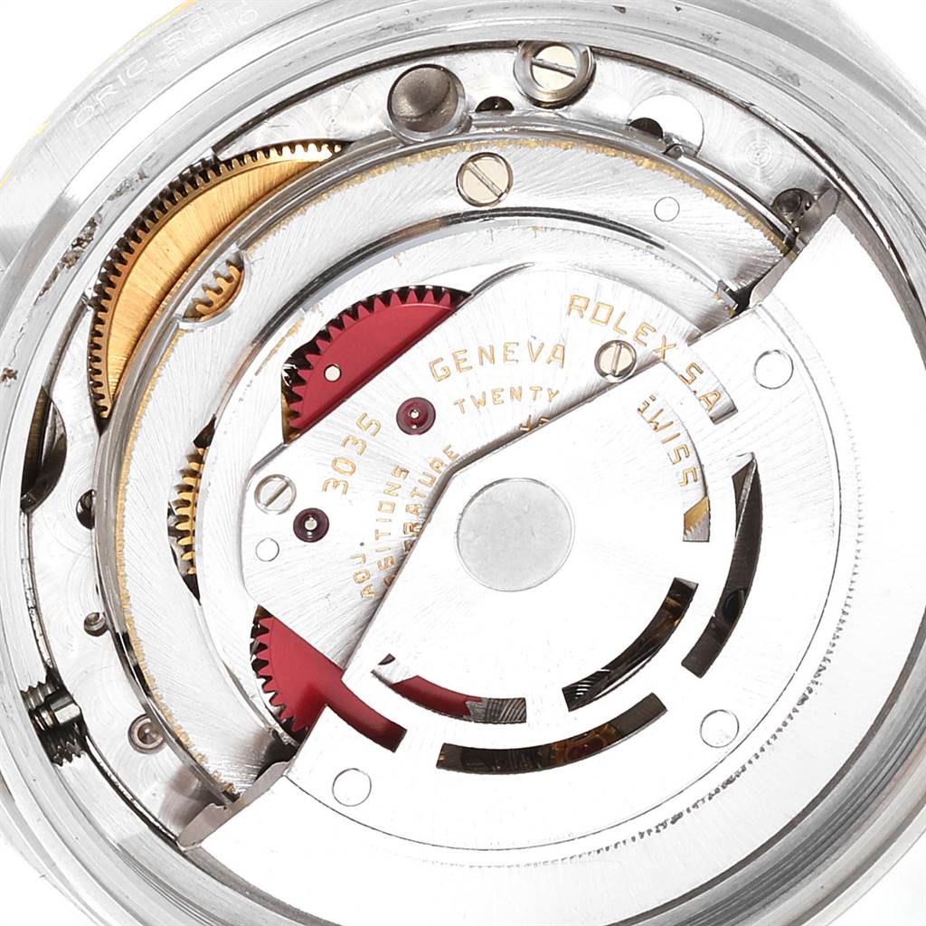 The image shows a close-up of the movement mechanism of a Rolex Datejust 16013 Men
s Steel and Gold (two tone) Champagne Dial 16013 Men
s Steel and Gold (two tone) Champagne Dial watch, focusing on its internal components and gears.