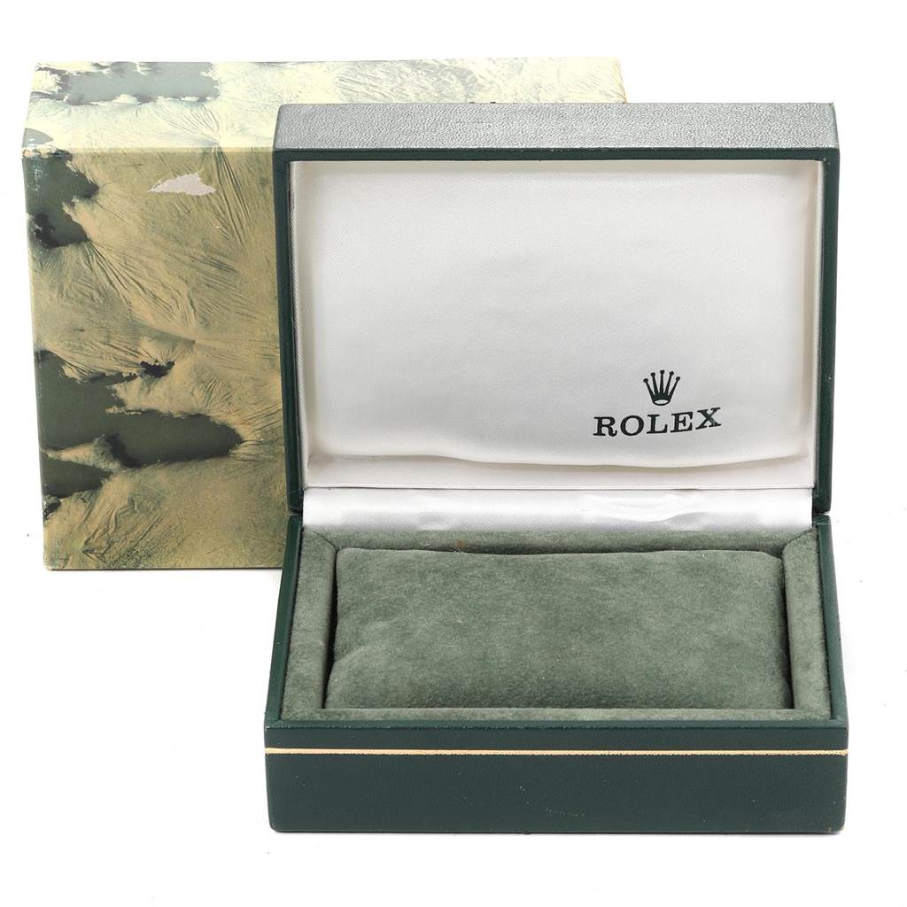 The image shows a Rolex Datejust 16013 Men
s Steel and Gold (two tone) Champagne Dial 16013 Men
s Steel and Gold (two tone) Champagne Dial watch box, opened, revealing a green cushion inside and the Rolex logo on the inner lid.