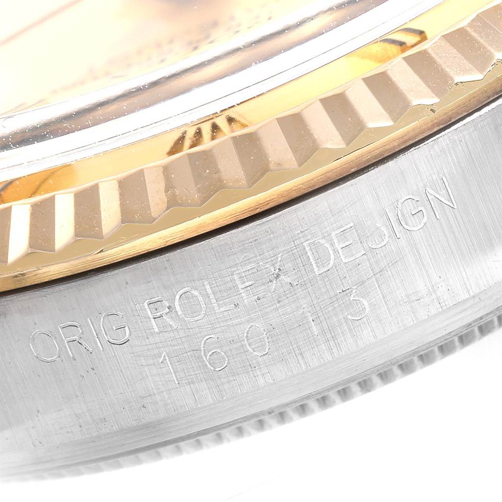 The image shows a close-up of the side of the bezel and case of a Rolex Datejust 16013 Men
s Steel and Gold (two tone) Champagne Dial 16013 Men
s Steel and Gold (two tone) Champagne Dial watch, with part of the serial number visible.