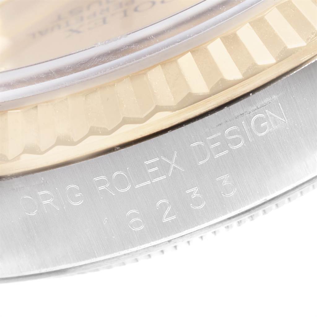 The image shows a close-up of the bezel and case side of a Rolex Datejust 16233 Men
s Steel and Gold (two tone) Champagne Dial 16233 Men
s Steel and Gold (two tone) Champagne Dial watch with the model number engraved.