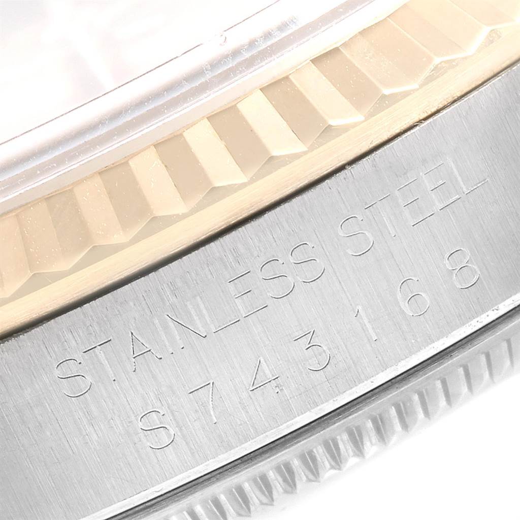 Close-up of the Rolex Datejust 16233 Men
s Steel and Gold (two tone) Champagne Dial 16233 Men
s Steel and Gold (two tone) Champagne Dial watch showing the stainless steel engraving and part of the fluted bezel.