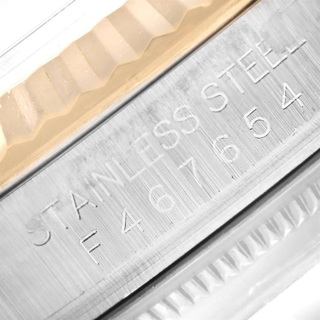 This image shows a close-up of the stainless steel casing with engraved details of a Rolex Datejust 116233 Men's Stainless Steel White Dial 116233 Men's Stainless Steel White Dial watch.