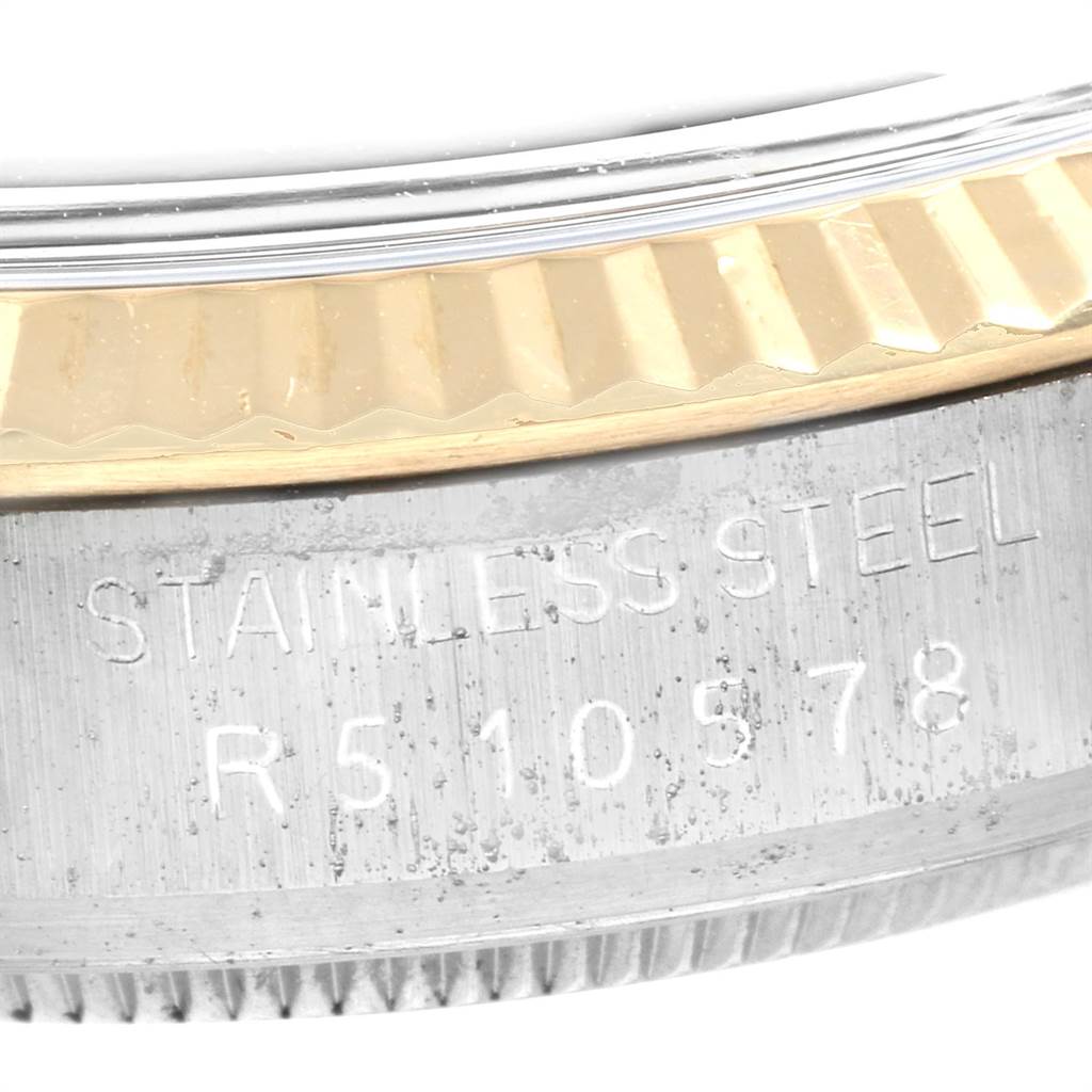 This image shows the fluted bezel and serial number engraving on the side of the case of a Rolex Datejust 16013 Men's Stainless Steel Champagne Dial 16013 Men's Stainless Steel Champagne Dial watch.