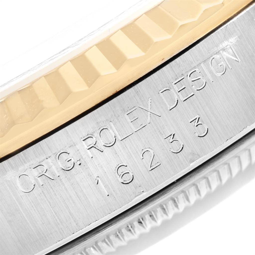 This is a close-up angle of the engravings on the side of the Rolex Datejust 16233 Men
s Steel and Gold (two tone) Champagne Dial 16233 Men
s Steel and Gold (two tone) Champagne Dial
s case, showing the model number and design details.