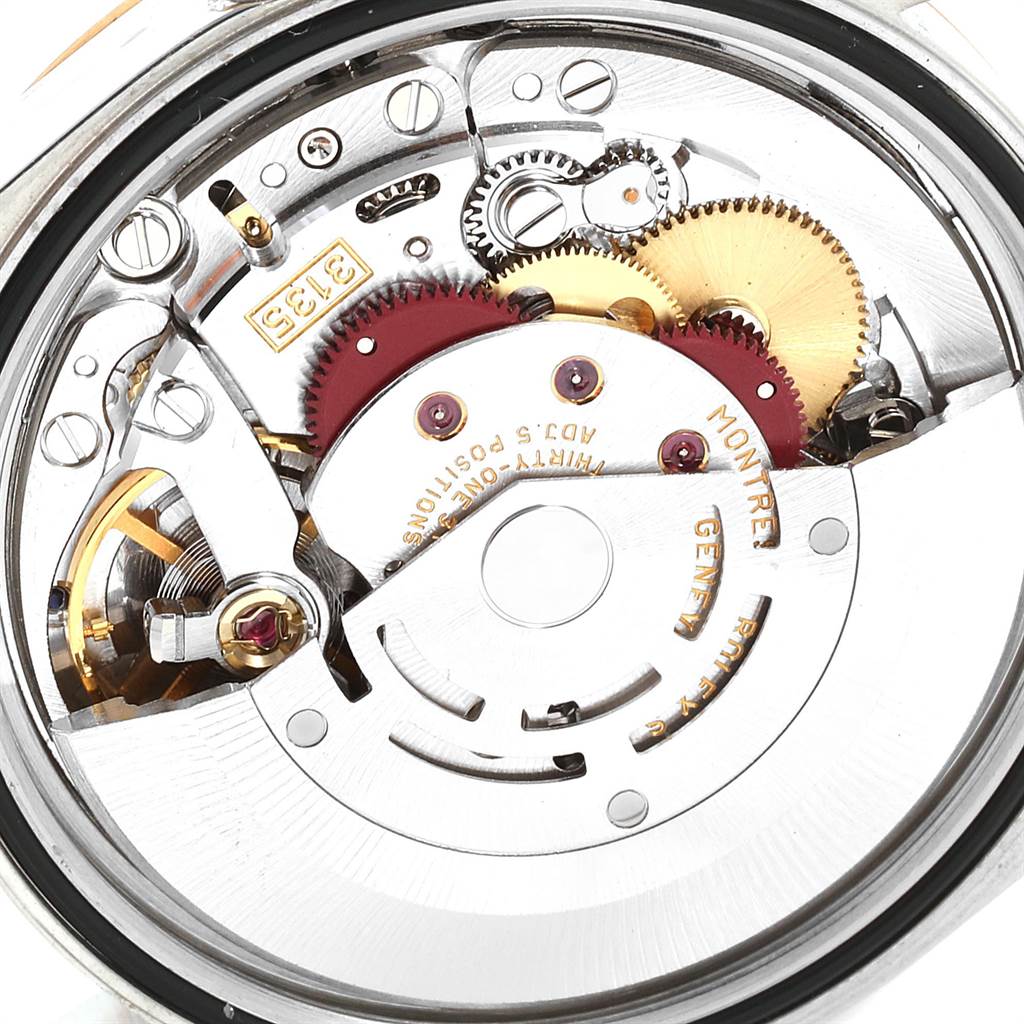 The image shows a close-up view of the internal mechanism of a Rolex Datejust 16233 Men
s Steel and Gold (two tone) Black Dial 16233 Men
s Steel and Gold (two tone) Black Dial watch, highlighting its gears and movement components.