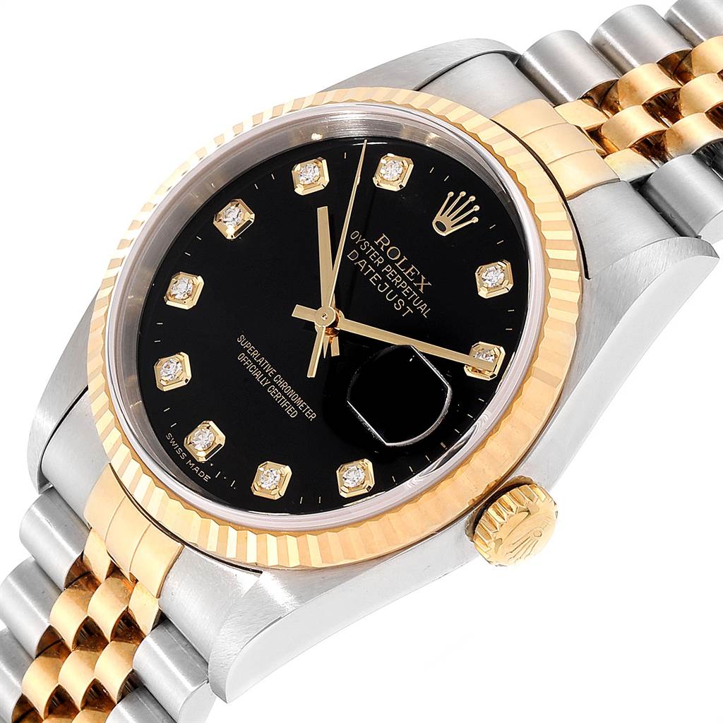 The image shows a close-up angled view of a Rolex Datejust 16233 Men
s Steel and Gold (two tone) Black Dial 16233 Men
s Steel and Gold (two tone) Black Dial watch, highlighting its face, bezel, and part of the bracelet.