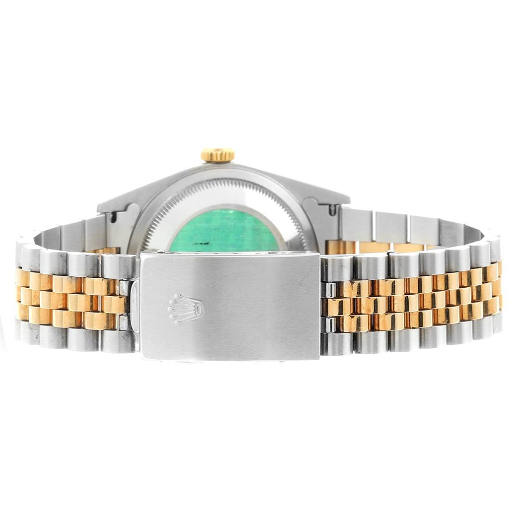 The image shows the back view of a Rolex Datejust 16233 Men
s Steel and Gold (two tone) Black Dial 16233 Men
s Steel and Gold (two tone) Black Dial, highlighting its two-tone bracelet and clasp with the Rolex logo.