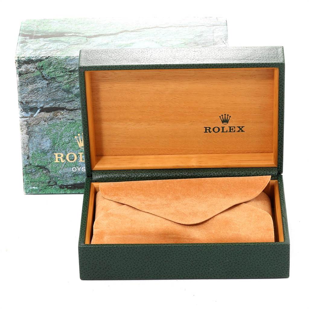 The image shows an open green Rolex Datejust 16233 Men's Steel and Gold (two tone) Silver Dial 16233 Men's Steel and Gold (two tone) Silver Dial watch box showcasing the interior with a wooden finish and brown suede padding inside.