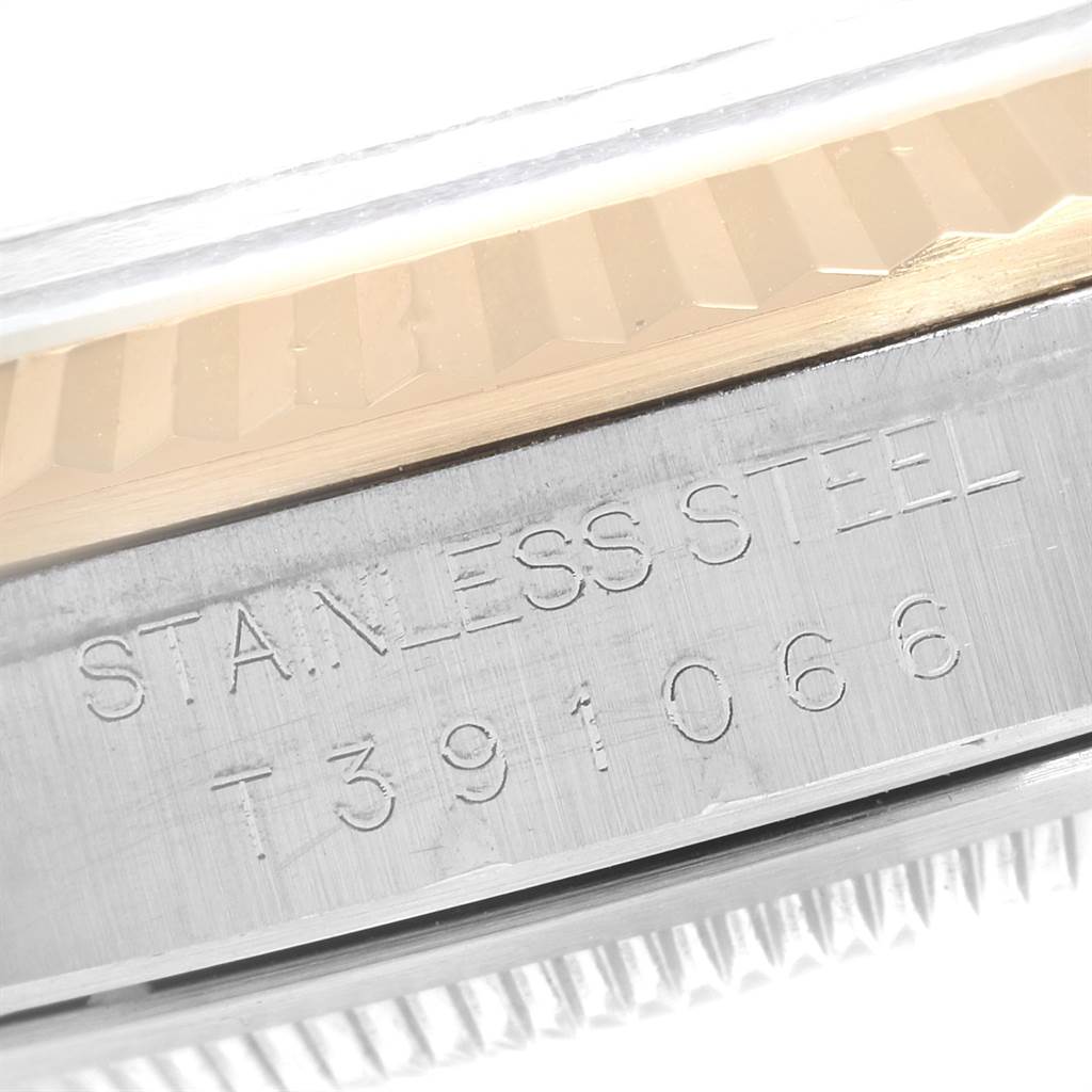 This image shows a close-up of the side of the Rolex Datejust 16233 Men's Steel and Gold (two tone) Silver Dial 16233 Men's Steel and Gold (two tone) Silver Dial watch, highlighting the "STAINLESS STEEL" engraving.