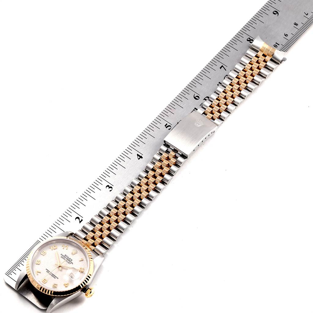The image shows a Rolex Datejust 16233 Men
s Steel and Gold (two tone) Beige Dial 16233 Men
s Steel and Gold (two tone) Beige Dial watch at a top-down angle, displaying the watch face and bracelet alongside a ruler for scale.