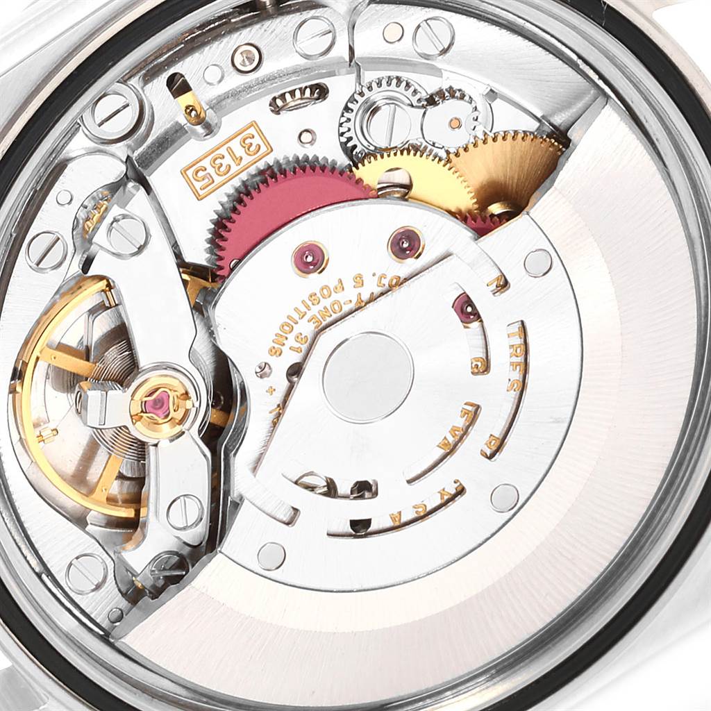The image shows the intricate internal mechanics and movement of a Datejust model by Rolex from a close-up, rear angle.