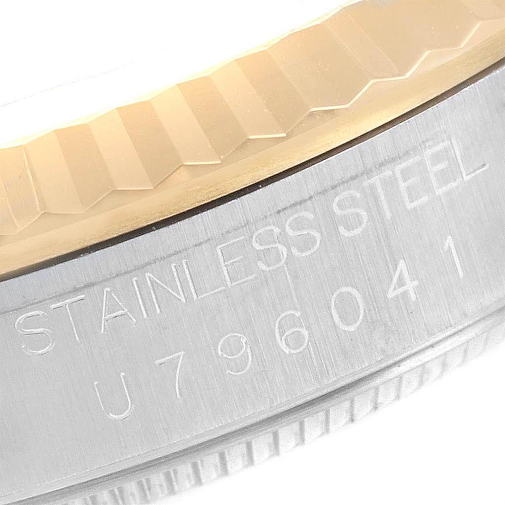 This image shows a close-up of the stainless steel case and fluted bezel of a Rolex Datejust 16233 Men
s Steel and Gold (two tone) Beige Dial 16233 Men
s Steel and Gold (two tone) Beige Dial watch.