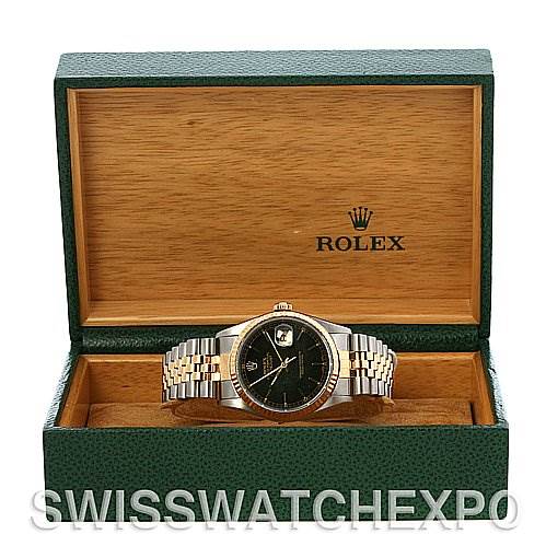 The image shows a Rolex Datejust 16233 Men's Stainless Steel Black Dial 16233 Men's Stainless Steel Black Dial watch displayed front-facing in an open green and wooden box.