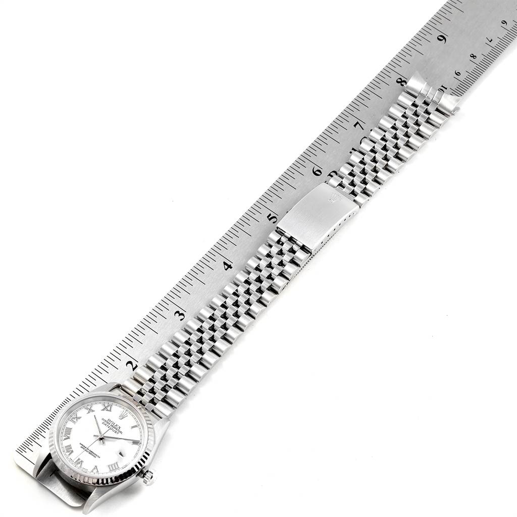 The image shows a Rolex Datejust 16234 Men's Stainless Steel White Dial 16234 Men's Stainless Steel White Dial watch laid flat next to a ruler to measure the length of its metal bracelet.