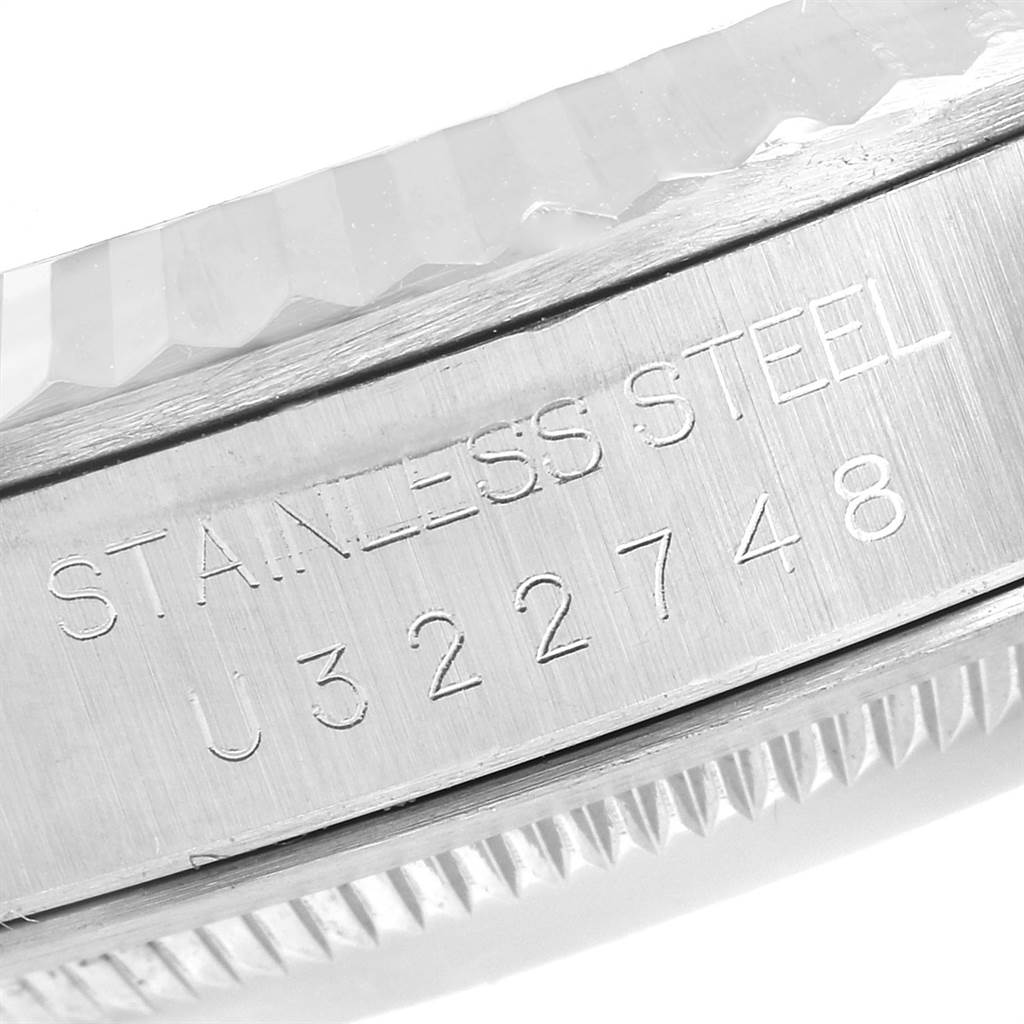 This close-up image shows the engraved serial number and stainless steel text on the case rim of a Rolex Datejust 16234 Men's Stainless Steel White Dial 16234 Men's Stainless Steel White Dial.
