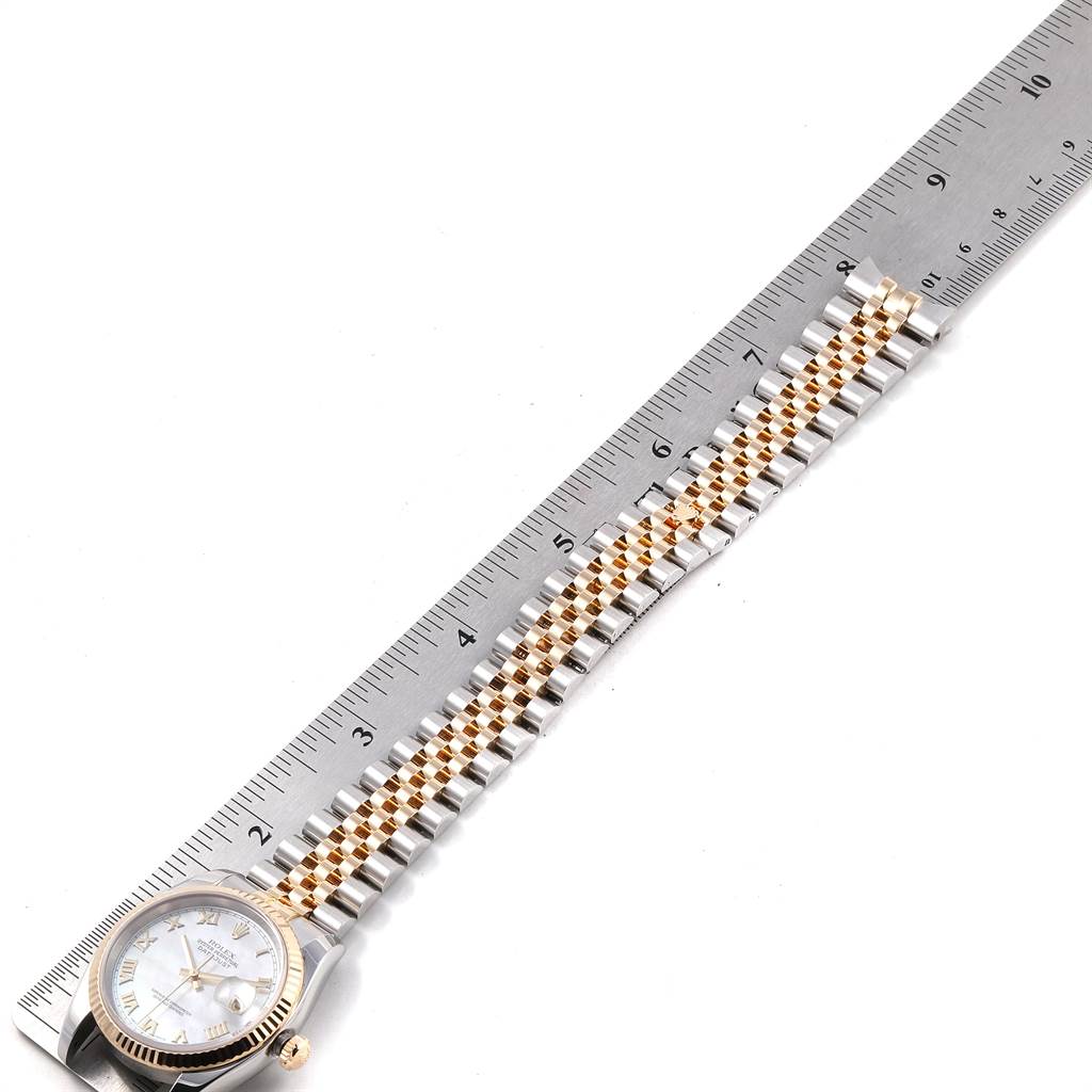 The image shows a Rolex Datejust 116233 Men's Stainless Steel Mother of Pearl Dial 116233 Men's Stainless Steel Mother of Pearl Dial watch laid flat with the face and two-tone bracelet visible next to a ruler.