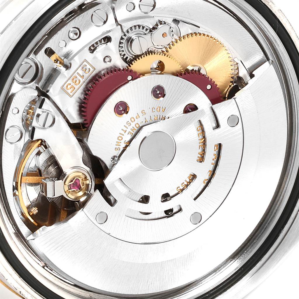 The image shows a close-up view of the movement inside a Rolex Datejust 116233 Men's Stainless Steel Mother of Pearl Dial 116233 Men's Stainless Steel Mother of Pearl Dial watch, highlighting gears and mechanical components.