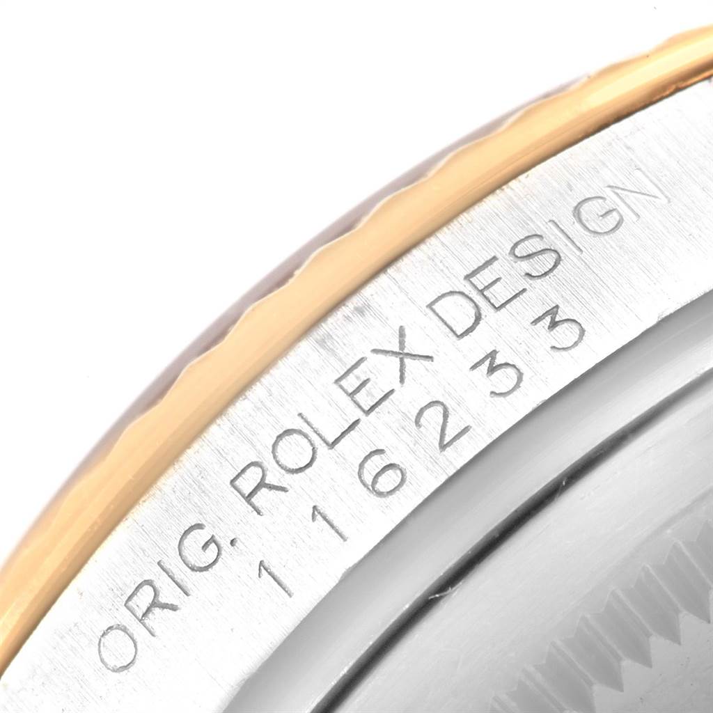 This close-up image shows the engraved bezel and part of the fluted edge of a Rolex Datejust 116233 Men's Stainless Steel Mother of Pearl Dial 116233 Men's Stainless Steel Mother of Pearl Dial watch model.