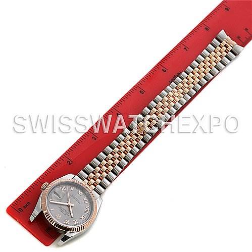 The image shows a Rolex Datejust 116231 Men's Stainless Steel Silver Dial 116231 Men's Stainless Steel Silver Dial watch from a top-down angle, highlighting the face, bezel, and full bracelet placed next to a red ruler.