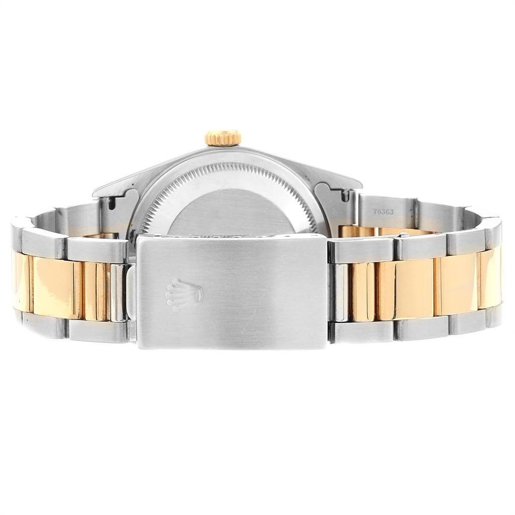 The image shows the back view of a Rolex Datejust 16203 Men's Steel and Gold (two tone) White Dial 16203 Men's Steel and Gold (two tone) White Dial watch, highlighting its metal case and two-tone bracelet with a clasp.