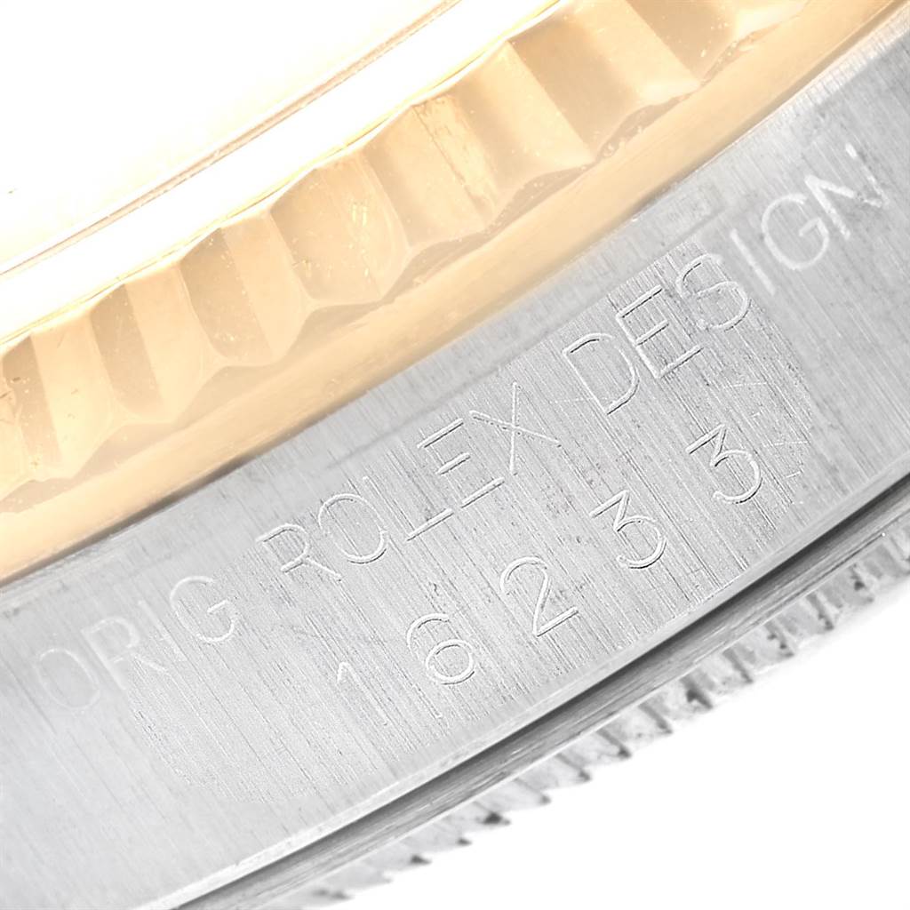 The image shows a close-up of the engraved side of the bezel and case on a Rolex Datejust 16233 Men
s Steel and Gold (two tone) Champagne Dial 16233 Men
s Steel and Gold (two tone) Champagne Dial watch.