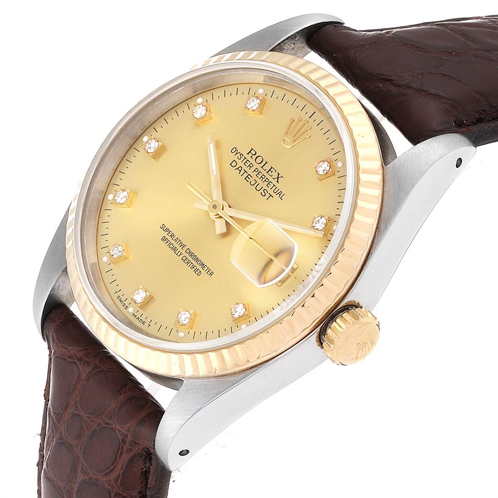 The image shows the Rolex Datejust 16233 Men
s Steel and Gold (two tone) Champagne Dial 16233 Men
s Steel and Gold (two tone) Champagne Dial watch with a gold dial, fluted bezel, diamond hour markers, and brown leather strap at a slight angle.