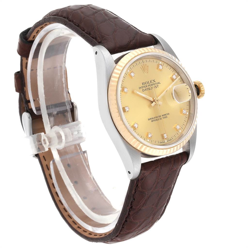 The image shows a Rolex Datejust 16233 Men
s Steel and Gold (two tone) Champagne Dial 16233 Men
s Steel and Gold (two tone) Champagne Dial watch from an angled side view, highlighting its face, bezel, case, and leather strap.