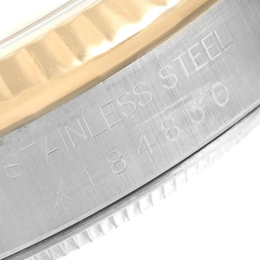 This image shows a close-up of the stainless steel side casing and part of the fluted bezel of a Rolex Datejust 16233 Men
s Steel and Gold (two tone) Champagne Dial 16233 Men
s Steel and Gold (two tone) Champagne Dial watch.