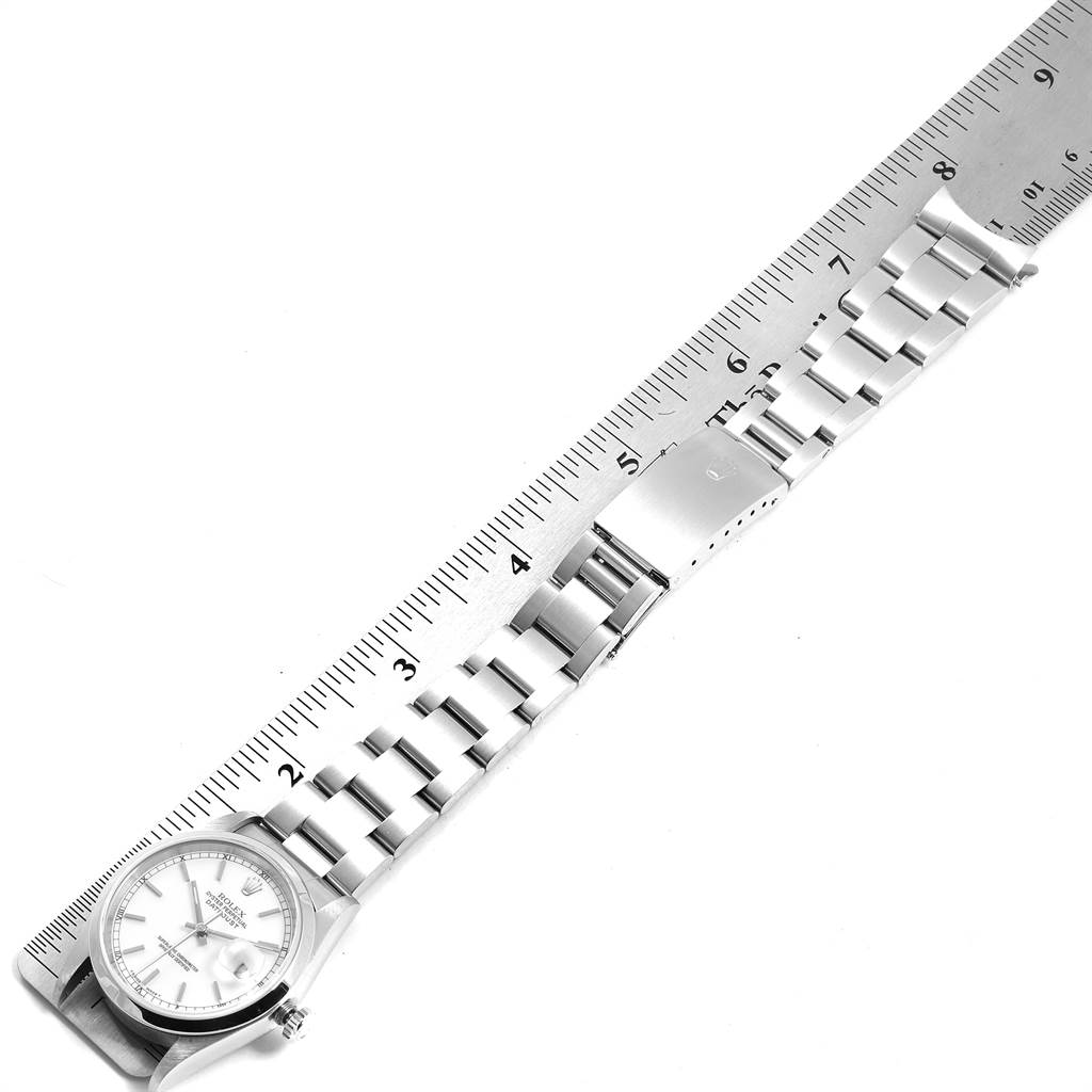 The image shows a top view of a Rolex Datejust 16200 Men's Stainless Steel White Dial 16200 Men's Stainless Steel White Dial watch, detailing its bracelet and clasp alongside a ruler for scale.