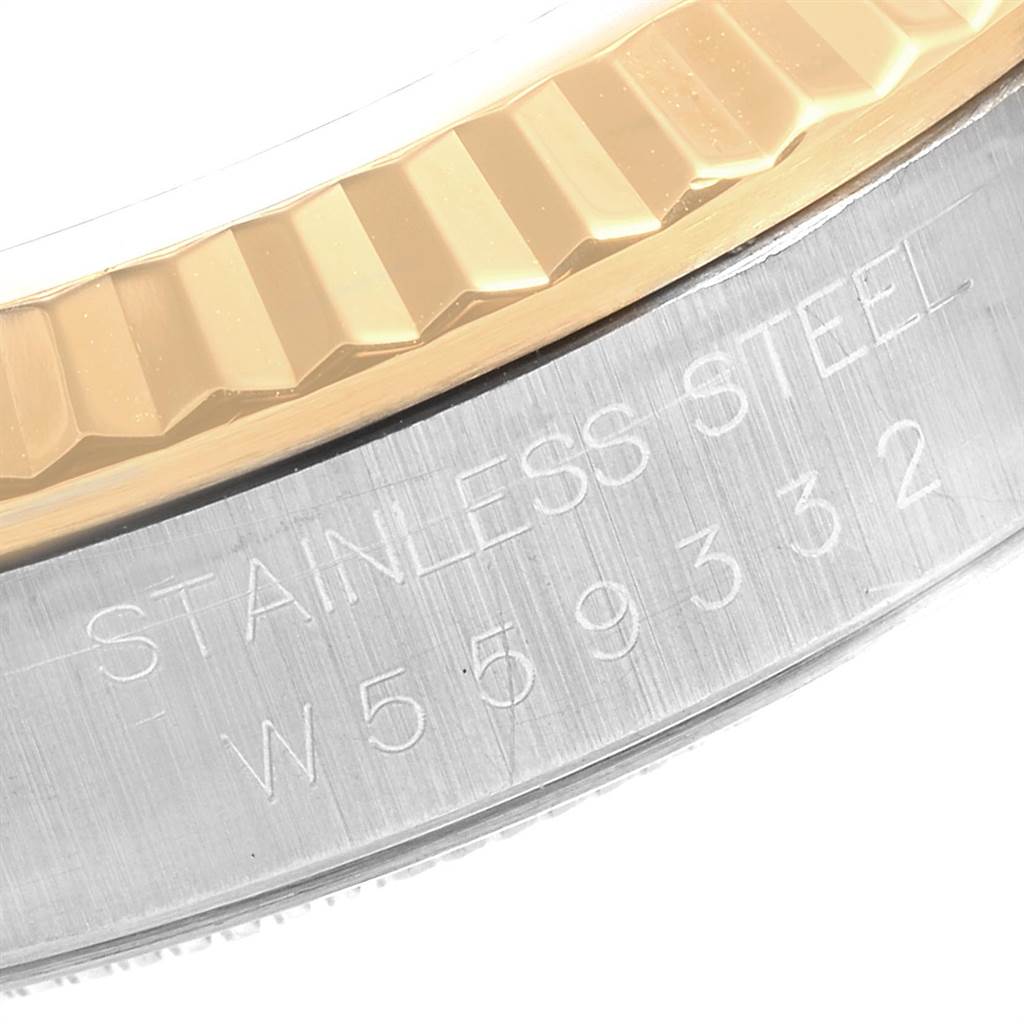 This image shows a close-up of the engraved, fluted bezel and stainless steel case of a Rolex Datejust 16233 Men
s Steel and Gold (two tone) Champagne Dial 16233 Men
s Steel and Gold (two tone) Champagne Dial watch.