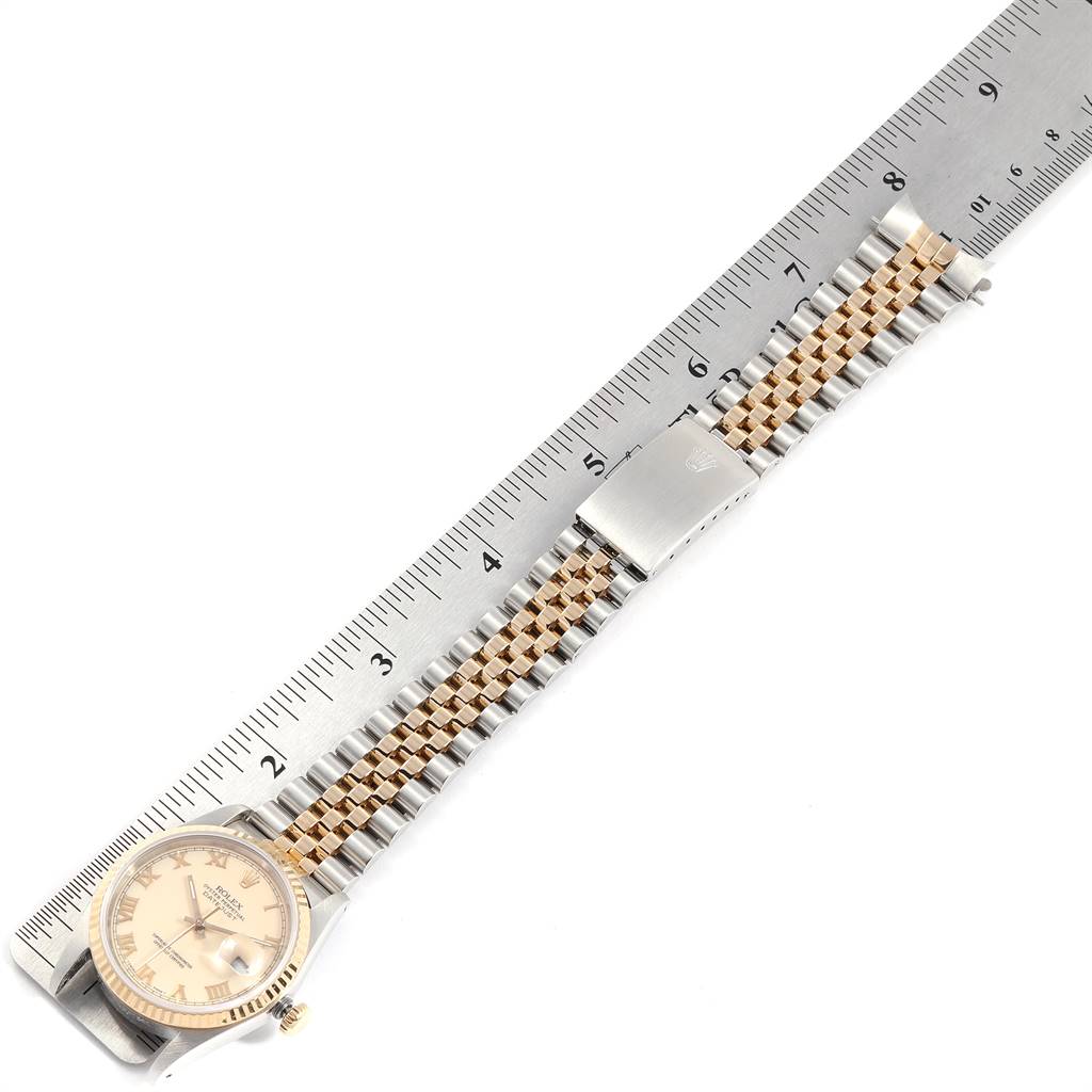 This image shows a Rolex Datejust 16233 Men
s Steel and Gold (two tone) Beige Dial 16233 Men
s Steel and Gold (two tone) Beige Dial watch and its bracelet laid flat beside a ruler for measurement.