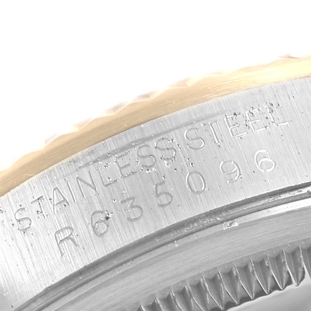 This close-up image shows the engraved serial number on the stainless steel case of a Rolex Datejust 16233 Men
s Steel and Gold (two tone) Beige Dial 16233 Men
s Steel and Gold (two tone) Beige Dial watch.
