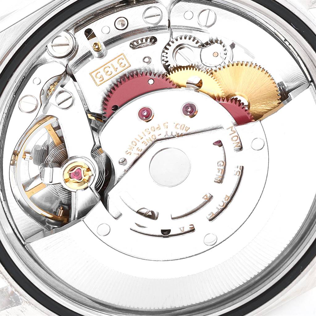 This image shows a close-up view of the movement mechanism of a Rolex Datejust 16233 Men
s Steel and Gold (two tone) Beige Dial 16233 Men
s Steel and Gold (two tone) Beige Dial watch, revealing its gears and intricate details.