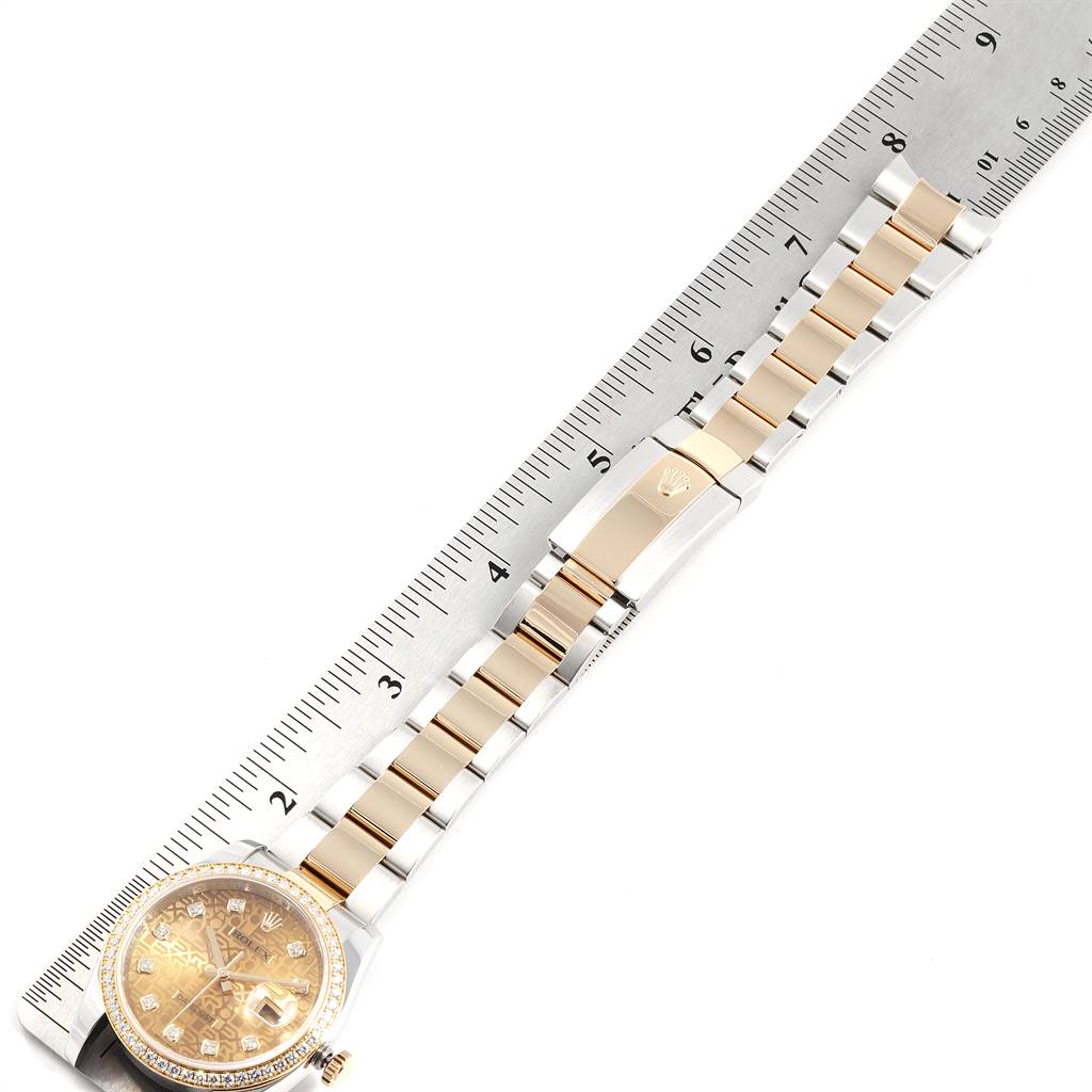 The image shows a top view of a Rolex Datejust 116243 Men's Steel and Gold (two tone) Champagne Dial 116243 Men's Steel and Gold (two tone) Champagne Dial watch, displaying the watch face, band, and clasp, with a ruler for scale.