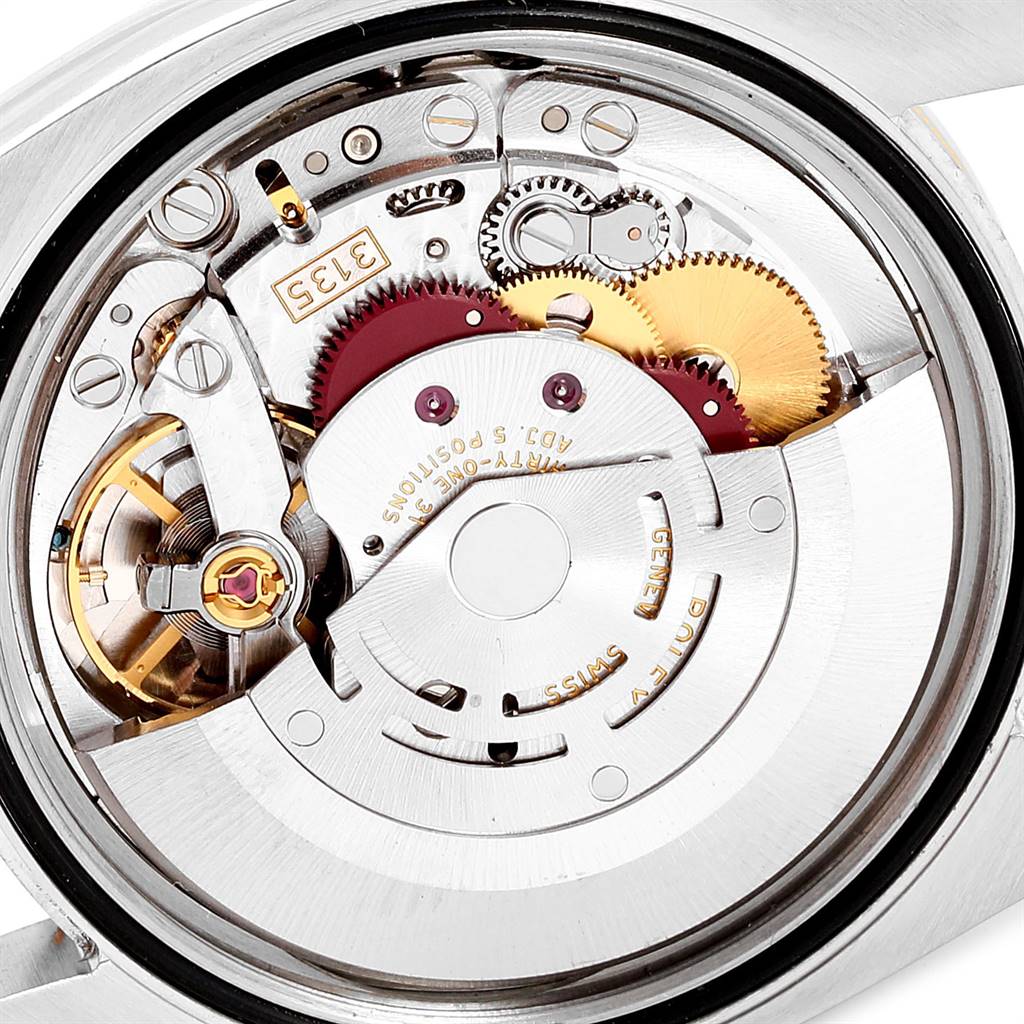 This image shows the internal mechanism of the Rolex Datejust 116243 Men's Steel and Gold (two tone) Champagne Dial 116243 Men's Steel and Gold (two tone) Champagne Dial watch from a close-up angle, revealing gears and other components.